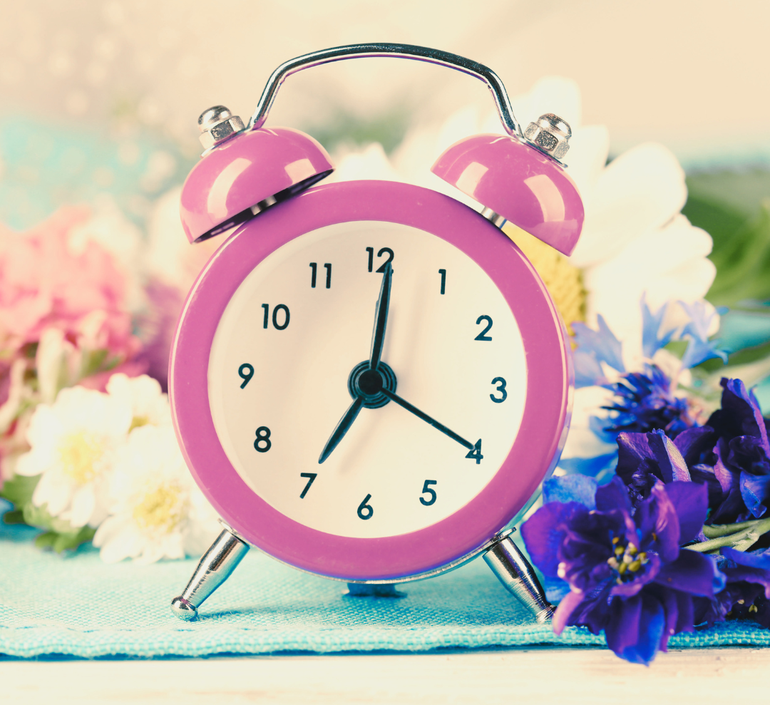 An image of a Pink alarm clock with flowers